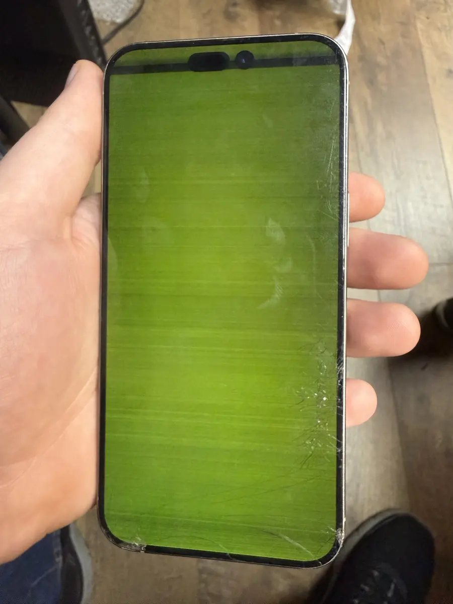iPhone with a cracked, green screen